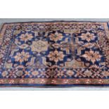 Chobi rug with an all-over stylised design on a midnight blue ground with borders, 168cms x 119cms