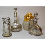 Two white metal mounted decanters (at fault), similar jug and a claret jug with gold plated mounts