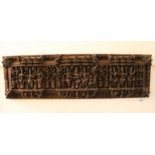 Indonesian carved hardwood figural decorated rectangular wall panel, 23cm x 82cm