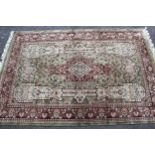 Turkish cotton silk style rug with medallion and all-over design on a pale green ground with rose