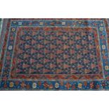 Kazak rug with an all-over stylised flowerhead and boteh design on a midnight blue ground with
