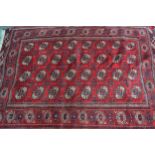 Turkoman rug with four rows of eight gols on a wine ground with borders (at fault), 2m 10cm x 1m