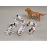 Six Royal Doulton figures of puppies, together with a Beswick figure of a Retriever
