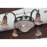 20th Century French black painted wrought iron light fitting with five mottled glass shades, the
