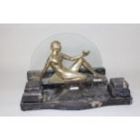Art Deco silvered spelter figure of a seated female nude on a marble base with glass back, 23 x 40cm