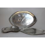 Continental silvered pewter oval dish relief decorated with a stag in a landscape, 51.5cm wide