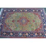 Tabriz rug with a lobed medallion and all-over stylised floral design on a pale green ground with