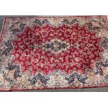 Kirman carpet with a central lobed medallion and all-over stylised floral design, on a rose pink