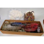 Two boxes containing a quantity of various Victorian dress feathers, a feather fan and a woolwork