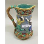 Minton Majolica jug decorated with dancing figures in relief, 24cms tall Holes to rim. Hairline