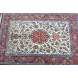 Small Isfahan rug with a medallion and vase design with subsidiary bird and floral motifs, on an