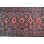 Small Afghan rug with two rows of six gols on a red ground with borders, 147 x 76cm