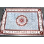 Modern machine woven rug with a circular medallion on a grey ground with borders, 286cms x 198cms