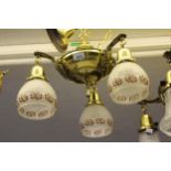 Brass three branch hanging light fitting with opaque floral and painted shades