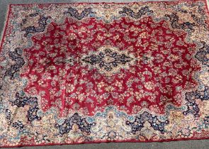 Kirman carpet with a central lobed medallion and all-over stylised floral design, on a rose pink