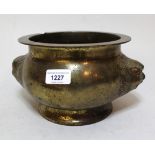 Chinese bronze two handled censer of circular squat baluster form with maskhead handles, 14 x 24cm