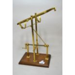 Reproduction brass decanting cradle on mahogany stand, 27cm wide x 36cm high approximately