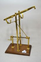 Reproduction brass decanting cradle on mahogany stand, 27cm wide x 36cm high approximately