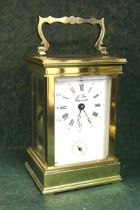 Small modern brass cased carriage clock with alarm function, the enamel dial with Arabic and Roman