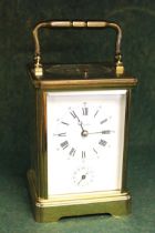 Brass cased carriage clock, the enamel dial with Arabic and Roman numerals, signed Angelus, the