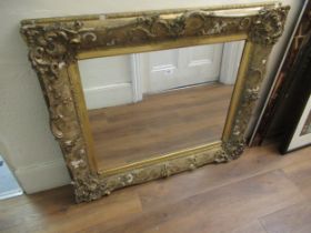 19th Century gilded composition frame housing a later rectangular mirror plate, 107 x 92cm (losses)