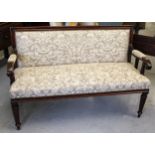 19th Century oak simulated as rosewood upholstered sofa with scroll arms, raised on turned hexagonal