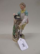Meissen figure of a boy standing beside a tree stump with a bird's nest in his hat, 18cm high (