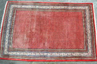 Serabend carpet with a typical all-over stylised Boteh design on a red ground with multiple borders,