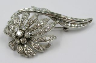 Unmarked high carat white metal and diamond set floral design brooch of Art Deco design,