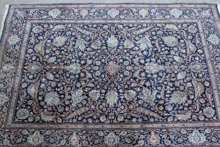 Indo Persian carpet with an all-over palmette and floral design on a midnight blue ground with