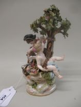 Meissen figural group with Cupid sharpening an arrow seated beneath a tree with another Cupid, 20.