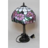 Reproduction bronzed composition table lamp with a leaded glass shade, 41cm high