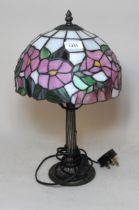 Reproduction bronzed composition table lamp with a leaded glass shade, 41cm high