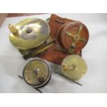 Early brass salmon reel with bone handle, two small brass fly reels and a mahogany starback reel