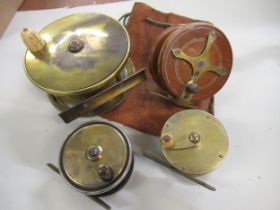 Early brass salmon reel with bone handle, two small brass fly reels and a mahogany starback reel