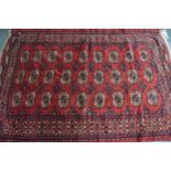 Tekke rug with three rows of nine gols on a wine ground with borders, 206 x 143cm approximately