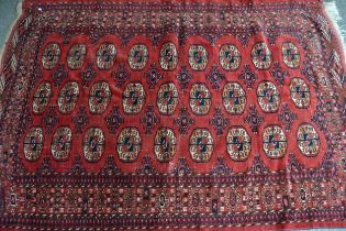 Tekke rug with three rows of nine gols on a wine ground with borders, 206 x 143cm approximately