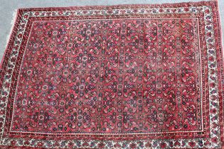 Hamadan carpet with all-over Herati design on a red ground with borders, 310 x 215cm (slight wear)