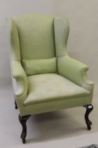 Early 20th Century upholstered wing armchair in Georgian style on mahogany cabriole supports