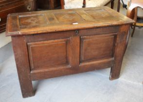 17th Century oak coffer, the hinged three panel lid above a two panel front on stile supports,