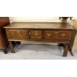 Small 18th Century oak dresser base, the plank top above three drawers with brass handles and