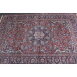 Tabriz rug with a lobed medallion and all-over palmette design on red ground, with palmette borders,