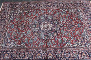 Tabriz rug with a lobed medallion and all-over palmette design on red ground, with palmette borders,