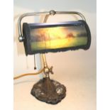 20th Century silvered adjustable desk lamp with shade, having handpainted landscape panel, signed