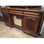 Victorian walnut sideboard with three frieze drawers above a central cupboard with mirror door,