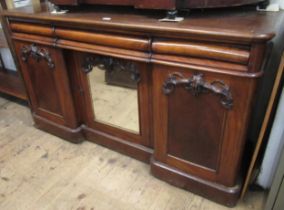 Victorian walnut sideboard with three frieze drawers above a central cupboard with mirror door,