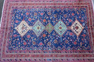 Modern Qashqai carpet with a pole medallion and all-over stylised floral design on a blue ground