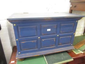 Modern blue painted panelled trunk with hinged cover, brass carrying handles and turned bun