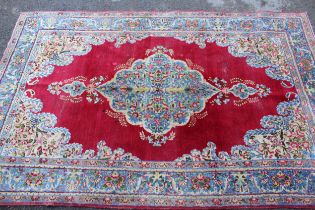 Pair of Indian rugs with a lobed medallion design on a wine ground with borders, 223 x 143cm each