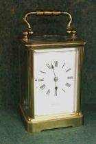 Small brass cased carriage clock, the enamel dial with Roman numerals, inscribed ' Examined by